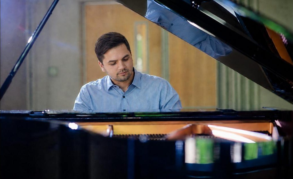 Thaddeus at an open grand piano